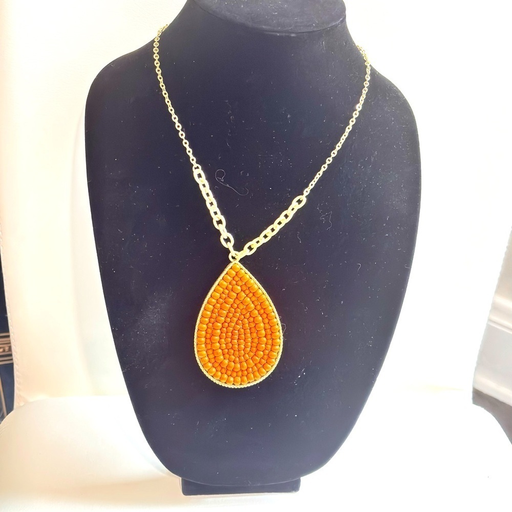 Plunder gold tone wooden beaded tear drop pendant